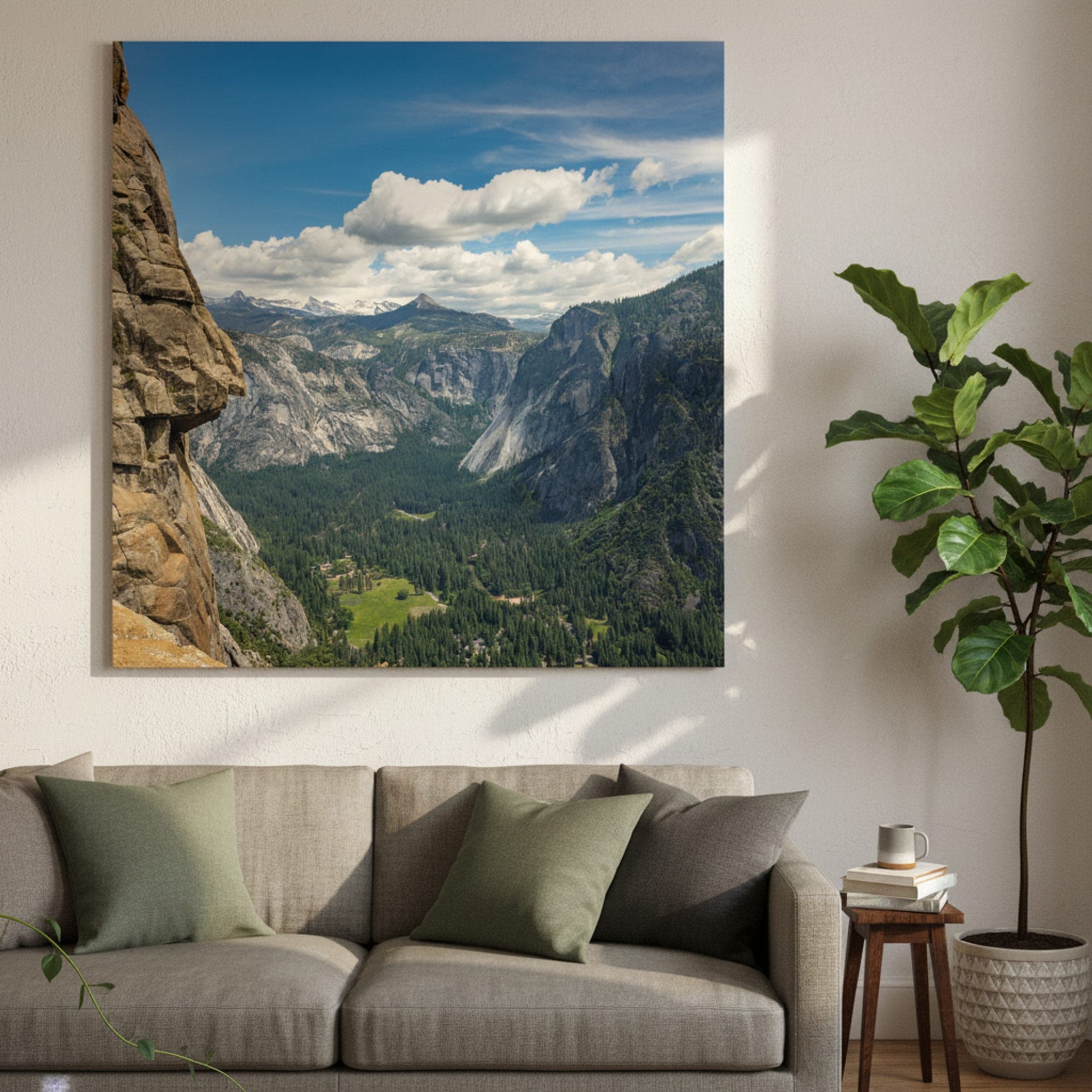 Yosemite Granite Majesty
A dramatic view of Yosemite Valley from a high vantage point, with a large granite cliff in the foreground and a vast, tree-filled valley and distant mountains under a blue, cloudy sky.